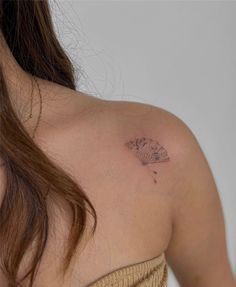 a woman with a butterfly tattoo on her shoulder