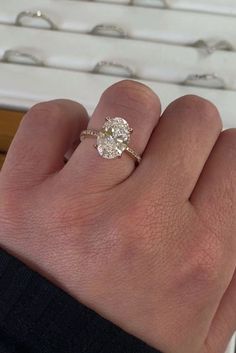 a person's hand with a diamond ring on it