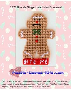 a cross stitch gingerbread man ornament on a pink background