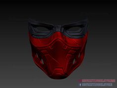 a red mask with goggles on it and black eyes in the middle, against a dark background