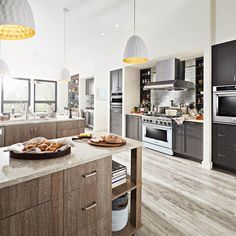 a large kitchen with an island and stainless steel appliances