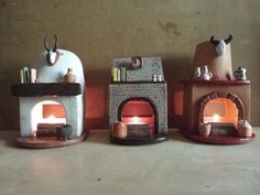 three small clay ovens sitting on top of a table next to eachother