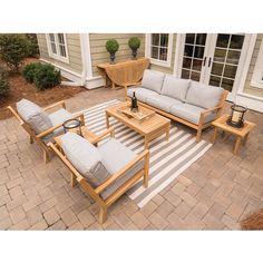 an outdoor patio with furniture and potted plants