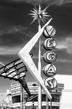 a black and white photo of the las vegas sign in front of an arena building