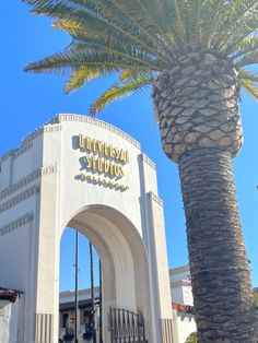 the entrance to universal studios with a palm tree