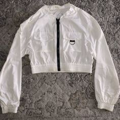 Nylon Material Windbreaker, Size S For Juniors And Is Cropped, It’s Very Comfortable And Stretches A Bit. From H&M Casual White Nylon Outerwear, White Stretch Tops With Pockets, White Long Sleeve Nylon Top, White Casual Nylon Tops, Casual Cropped Nylon Outerwear, H&m Casual Summer Outerwear, Chic White H&m Outerwear, White Fitted Outerwear By H&m, H&m White Spring Outerwear