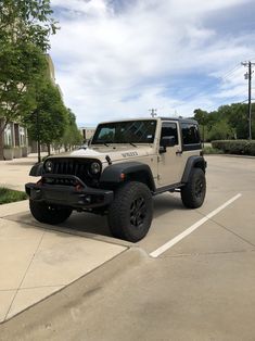 a white jeep parked in a parking lot