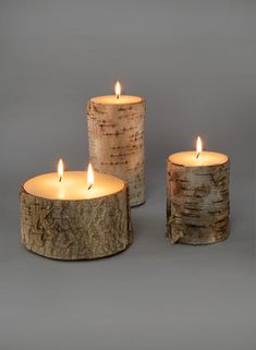 three lit candles sitting next to each other