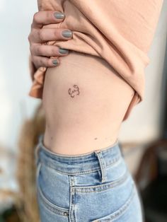 a woman with a small tattoo on her stomach