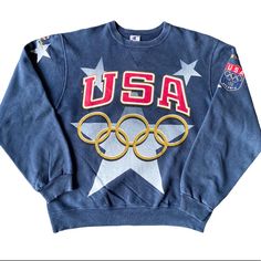 Preowned In Good Vintage Condition Champion 100 Atlanta Usa Olympics Sweater. Normal Wear, Heavy Fade, Navy, Usa Olympic Logo Large On Front, Stars And Champion Spell-Out Logo On Right Upper Sleeve, Name On Left Usa Atlanta Shield, Embroidered Champion Logo On Left Wrist, Blank On Back, 90s Vintage, Amazing One Of Kind Flare! Size Large. Measurements: Length-26.5” Chest-23.5” Collar To Arm-31.5” Olympic Logo, Atlanta Usa, Merch Ideas, Usa Olympics, Champion Logo, Team Usa, 90s Vintage, Colorful Sweaters, Atlanta