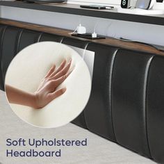 a person's hand on top of a headboard in front of a computer desk