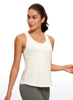 a woman in grey leggings and a white tank top