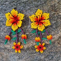 These beaded earrings come from many different families of the Wixarika(Huichol) Nation who reside in TaTeki village of San Andres, Jalisco Mexico. These pieces were purchased on pilgrimage to Wixrikuta from families who do not have the opportunity to leave and sell their art outside of the villages. Purchasing this artwork helps the locals buy food, clothing, school supplies for their children, and also candles for their prayers and offerings. For many of these artisans, this work is their only Traditional Handmade Flower Earrings For Festivals, Handmade Traditional Flower Earrings For Festivals, Traditional Handmade Flower Earrings, Yellow Handwoven Beaded Earrings For Festivals, Festival Yellow Handwoven Beaded Earrings, Yellow Handwoven Festival Earrings, Traditional Handmade Flower Earrings As Gift, Traditional Handmade Flower Earrings For Gift, Traditional Yellow Beaded Earrings With Dangling Beads