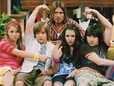 a group of kids sitting on top of a couch in front of a tv screen