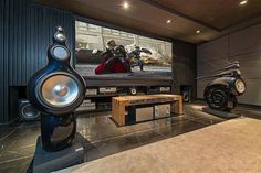 an entertainment room with two speakers and a large screen