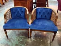 two blue chairs sitting next to each other