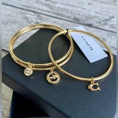 Nwt! Coach Set Of 3 Bangle Bracelets With Charms. Gorgeous Set In Golden Tone, Each With A Different Charm. Use Them Together Or Separately! Authentic Designer Brand. Come In Jewelry Box. Brand New With Tags. This Is A Beautiful Set! Each Bangle Measures Approx 2.5 Inches In Diameter. Just One Set Like This Left! This Is The Last One, Get It Before It’s Gone! Check Out The Rest Of The Coach Jewelry And Accessories Available In My Closet! New To Poshmark? Sign Up Now With My Code Mmrt330 To Save Woman Hygiene, Coach Bracelets, Bracelets With Charms, Coach Jewelry, List Ideas, Bangle Bracelets With Charms, Jewelry Lookbook, Gold Accessories, Girly Jewelry