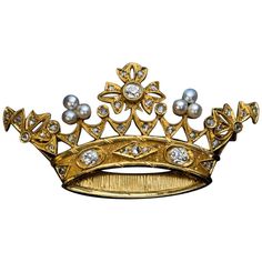 Circa 1890s This Belle Epoque openwork gold brooch is finely modeled as a royal crown embellished with pearls, old mine and rose cut diamonds. The three principal diamonds are bright white (E-F color) old mine cut stones with approximate weight of 0.23 ct, 0.19 ct, 0.17 ct (VS1, VS2, SI2 clarity). Estimated total diamond weight is 1.06 carat. Length 55 mm (2 3/16 in.) Height 29 mm (1 1/8 in.) The brooch is almost certainly a royal presentation piece. Antique Crown, Expensive Jewelry Luxury, Diamond Crown, Garnet And Gold, Gold Brooch, Antique Brooches, Diamond Brooch, Expensive Jewelry, Gold Brooches