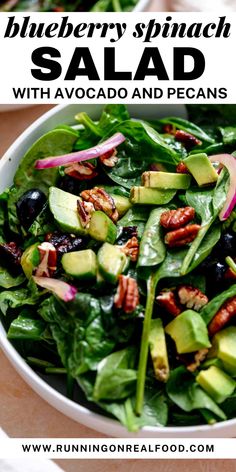 blueberry spinach salad with avocado and pecans in a white bowl