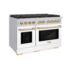 a white and gold stove with two ovens on each burner, one in the middle