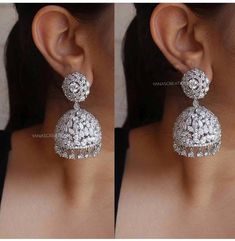 Add charm and charisma to your beautiful personality with these exquisitely handcrafted zircon jhumkas made with high quality German Silver and studded with real AD and zirconia  stones which gives these earrings a very contemporary and striking look. Wear them with any formal or casual attire and win compliments all the way! Each earring weighs 32 GM's approxLength 3 inches approx Silver Bridal Earrings With Stone Work For Reception, Silver Drop Earrings For Reception, Fusion Style Bridal Earrings With Stone Work For Party, Fusion Style Bridal Earrings For Party With Stone Work, Reception Chandelier Earrings With Stone Work, Fusion Style Danglers With Stone Work For Party, Silver Stone Work Earrings For Reception, Silver Jhumkas With Stone Work For Reception, Fusion Stone Work Earrings For Party