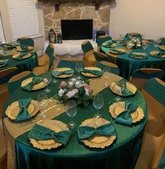 the table is set with green and gold plates, napkins, and place settings