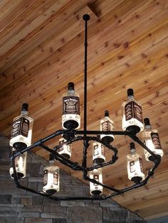 a chandelier made out of bottles is hanging from the ceiling