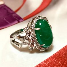 MADE TO ORDER ONLY! 1 week gold crafting period. EXTREMELY VIVID, Certified 7.57 carats, COLOMBIAN Emerald ring. SUGGESTED RETAIL VALUE: $18,000 EMERALD: Weight: 6.63 carats Shape: Oval Cabochon Dimensions: 9.27 x 14.73 x 5.90 mm Color: Green Origin: COLOMBIAN NATURAL EMERALD WITH OIL TREATED ONLY (F3) Gemological certificate provided as shown. TRANSPARENT EXTREMELY CLEAN EXCELLENT COLOR AND CUT! RARE VIVID, COLOMBIAN, BLUISH-GREEN COLOR!! DIAMONDS: 50 round brilliant diamonds weighting a total Luxury Oval Cabochon Gemstones For Anniversary, Formal Hallmarked Diamond Cabochons, Luxury White Gold Diamond Cabochons, Formal Emerald Cabochon Diamond Ring, Luxury Emerald Cabochon Ring With Diamonds, Luxury White Gold Oval Cabochon Emerald Ring, Exquisite Gia Certified Round Gemstones, Luxury Diamond Cabochons For Wedding, Exquisite Formal Gemstone Cabochons