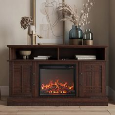 an entertainment center with a fireplace in the middle and a painting on the wall behind it