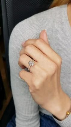 a woman wearing a diamond ring on her finger