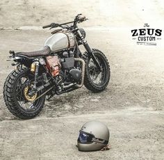 a motorcycle parked on top of a dirt field next to a helmet with the caption'no 1 top 10 best of zeius '