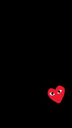 a red heart on a black background with two eyes in the middle and one eye closed