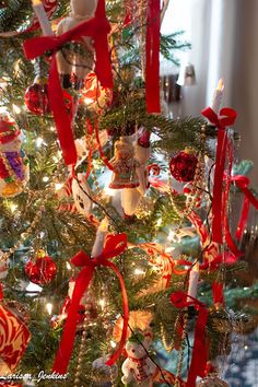 a decorated christmas tree with red and white ornaments