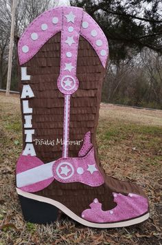 a cowboy boot is decorated with pink and brown glitters on the bottom, and white polka dots at the top