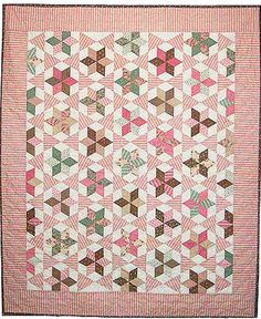 a pink and brown quilt with many small squares on the front, along with two rows of smaller blocks