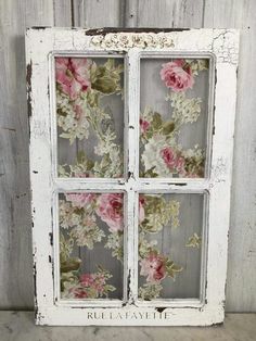 an old window with flowers painted on it