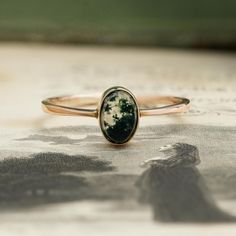 A beautiful Edwardian 9ct gold moss agate single-stone ring. Timelessly set into a gold band with slightly tapered shoulders and an open back setting to allow light to pass through the stone, revealing its inner hidden world; rivulets of forest green, spreading through the stone like drops of ink. Moss agate is thought to be a balancing, healing stone, with the ability to enhance energy and ignite creativity.  "Green is the fresh emblem of well-founded hopes." ~ Mary Webb FINER DETAILS: ERA:  Ed Single Stone Ring, Green Moss Agate, Moss Agate Ring, Single Stone, Agate Ring, Healing Stone, Moss Agate, Gold Band, Stone Ring