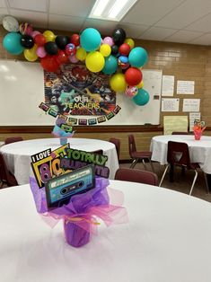 a party with balloons and decorations in the shape of a boom box on top of a table