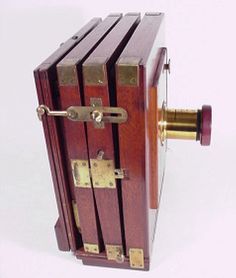 an old fashioned wooden box with brass hardware