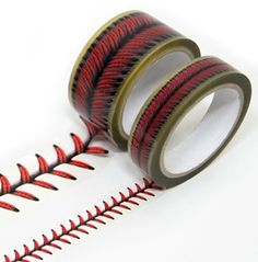 two rolls of red and black washi tape sitting next to each other on a white surface