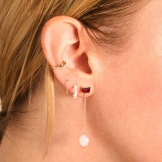 A woman with her blonde hair tucked behind her ear models for earrings. The first has a rectangular garnet stud with a fresh pearl connected by a dangling chain. Elegant Red Ear Cuff As Gift, Elegant Red Ear Cuff For Gift, Elegant Red Ear Cuff Gift, Garnet Earrings, Garnet, Pick Up, Yellow Gold, Yellow, Gold