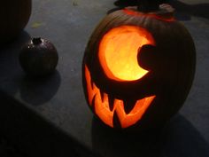 two carved pumpkins sitting on top of a table