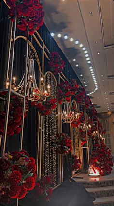 red roses and chandeliers are hanging from the ceiling