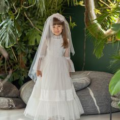 Introducing the epitome of elegance and grace - the Premium Tulle White Lace Communion Dress with Sleeves. This exquisite long-sleeved communion dress is designed to make your little one feel like a princess on her special day. Crafted with meticulous attention to detail, this dress features delicate white lace that adds a touch of sophistication. The premium tulle fabric drapes beautifully, creating a stunning silhouette that will leave everyone in awe. Elegant Long Sleeve Confirmation Dress, Elegant Long Sleeve Dress For First Communion, White Long Sleeve Confirmation Dress, First Holy Communion Dresses, Holy Communion Dresses, Flower Girl Wedding, Ivory Flower Girl, Ivory Flower Girl Dresses, Baptism Outfit