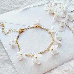 a bracelet with white flowers on it