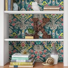 a book shelf with books, vases and other decorative items on top of it