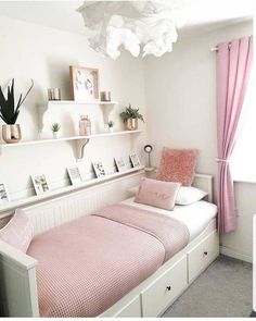 a bedroom with pink and white decor in the corner, including a twin size bed