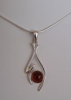 Pendant - silver 925 with natural Baltic amber in a shade of cognac with a diameter of 8 mm (0.31 inch). The length of the pendant with a pendant 42 mm (1.65 inches), width 15 mm (0.59 inches), weight 2.3 g. The price includes only the pendant without a chain. The product is made using a unique technique, hand-made and design, modern, subtle and individual created for women who like interesting and unique designs. Allow yourself a little pleasure. Welcome. We also invite you to familiarize yours Adjustable Bronze Symbolic Necklace, Artisan Adjustable Pendant Crystal Necklace, Artistic Bronze Pendant Necklace, Bronze Symbolic Pendant Necklace, Amber Sterling Silver Pendant Necklace, Silver Necklace Designs, Body Jewelry Piercing, Jewelry Making Tutorials, Cognac