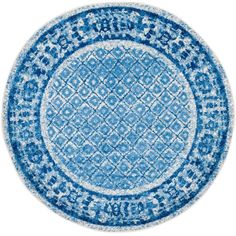 a blue and white rug with an intricate design on the center, in front of a white background