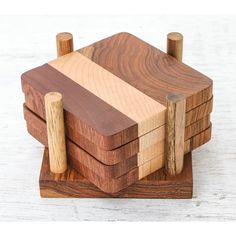 a wooden toy with four pieces of wood stacked on top of each other and one piece missing